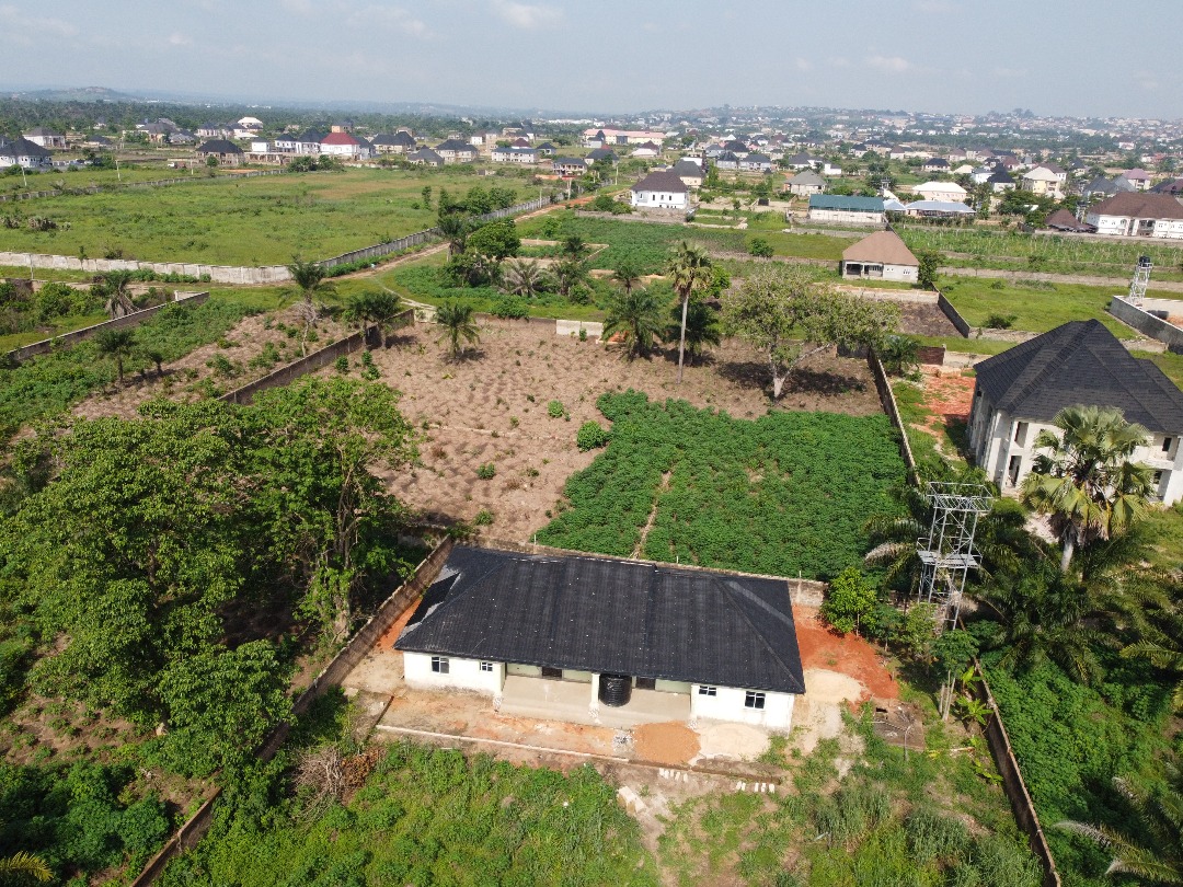 MORETHAN 5 PLOTS OF LAND WITH 2 UNITS OF THREE BEDROOM FLATS INSIDE THE COMPOUND